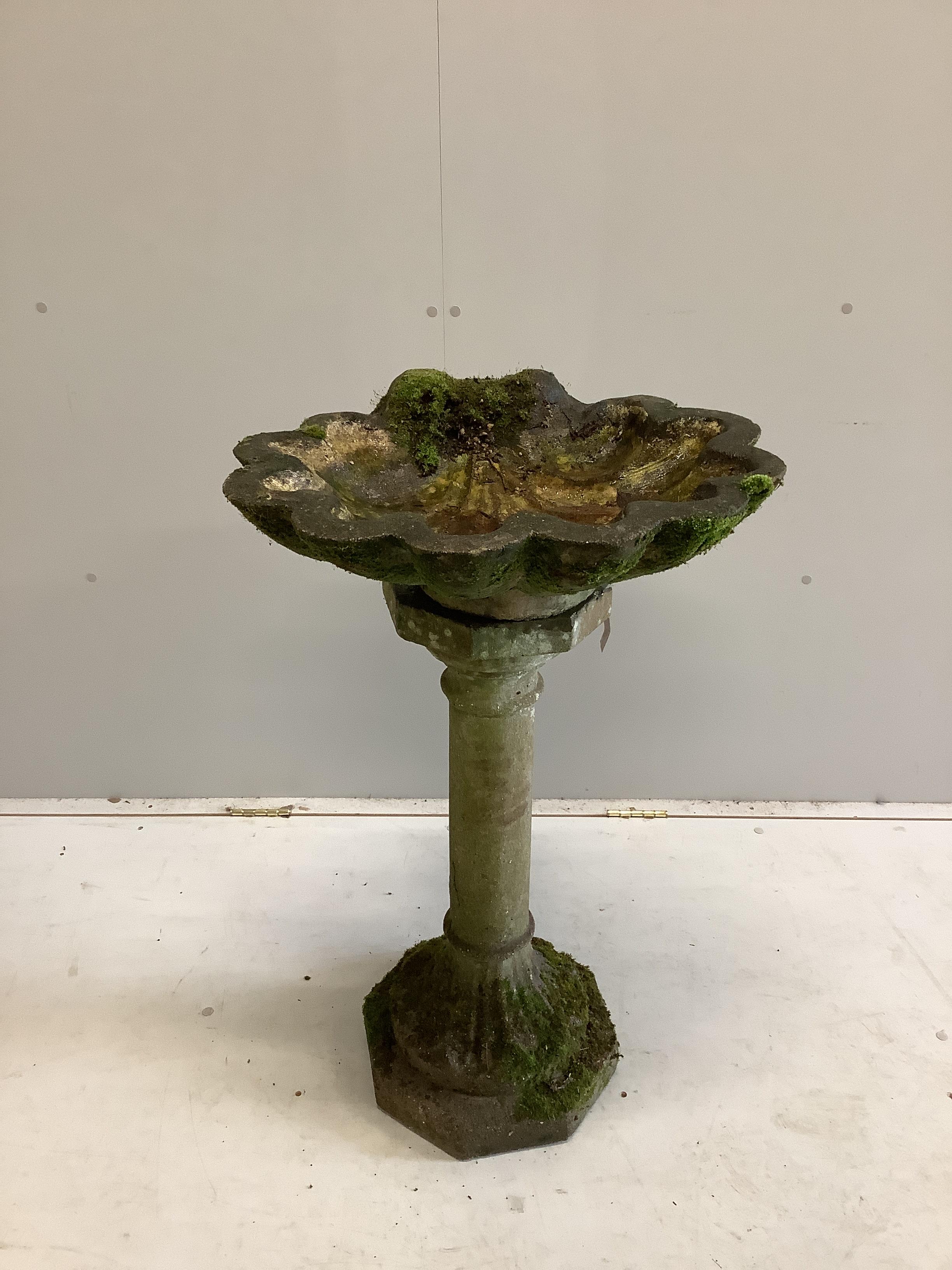 A reconstituted stone scallop shell bird bath, width 56cm, height 90cm